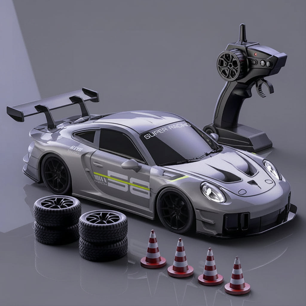 Toy racing car with remote control, tires, and cones on a gray background