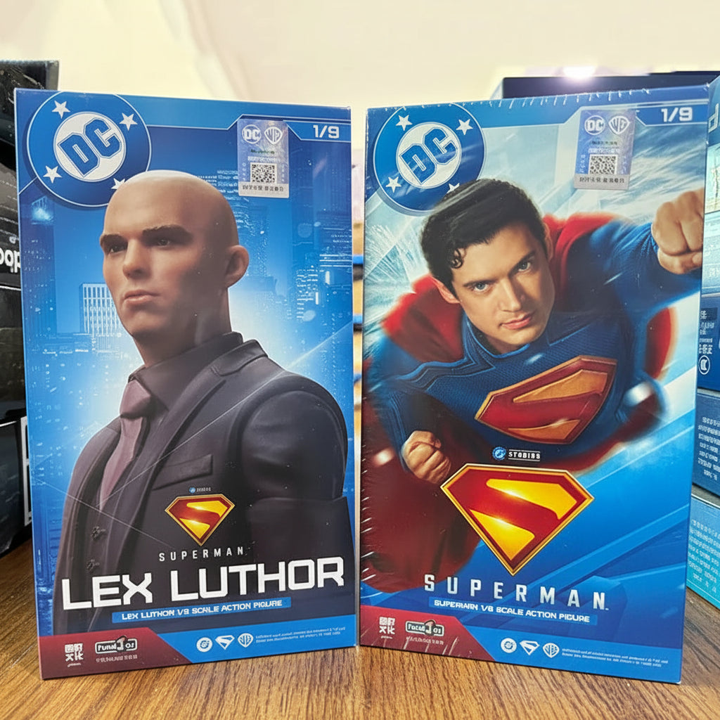 Two action figure boxes from DC, one featuring Lex Luthor and the other Superman, on a blue surface.